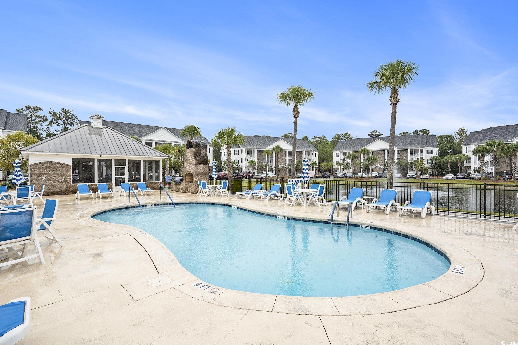 124 Birch N Coppice Drive, Unit 3 Surfside Beach, SC 29575 - Photo 38 of 40 Community pool with a patio area and a residential view