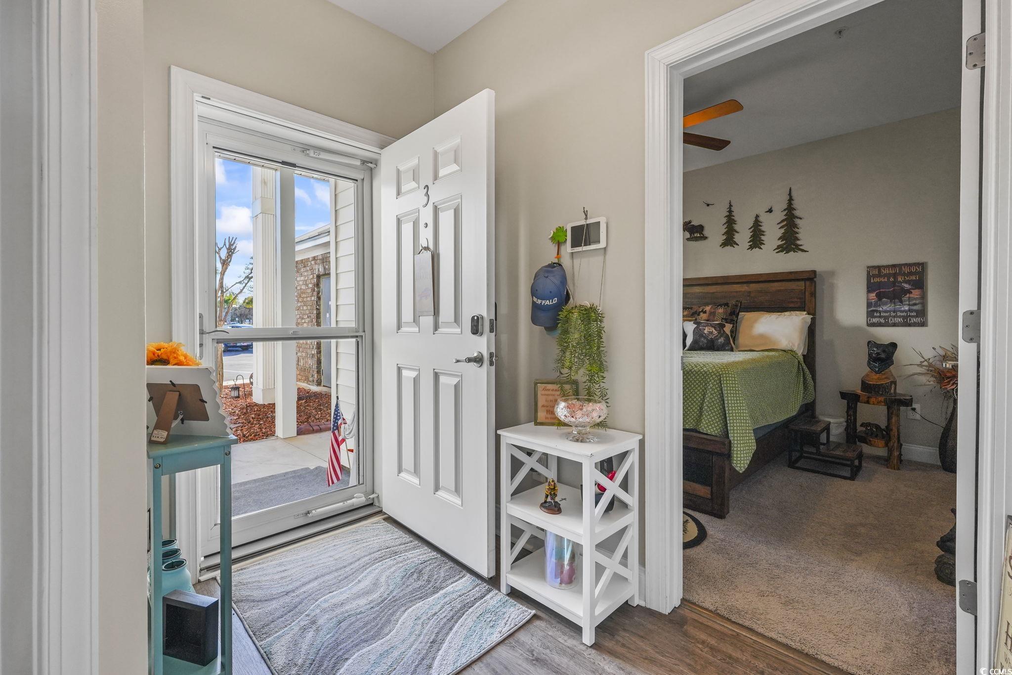 124 Birch N Coppice Drive, Unit 3 Surfside Beach, SC 29575 - Photo 7 of 40 Doorway featuring wood finished floors and carpet