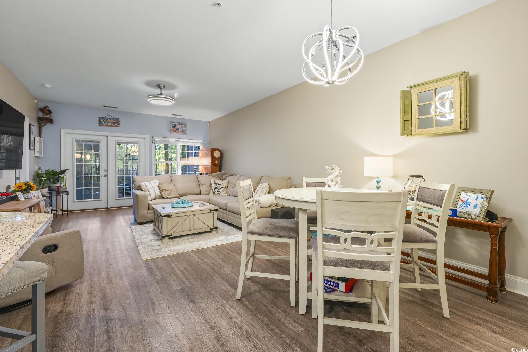 124 Birch N Coppice Drive, Unit 3 Surfside Beach, SC 29575 - Photo 9 of 40 Living area featuring wood finished floors and french doors