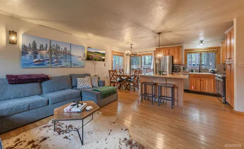 a living room with furniture rug and wooden floor
