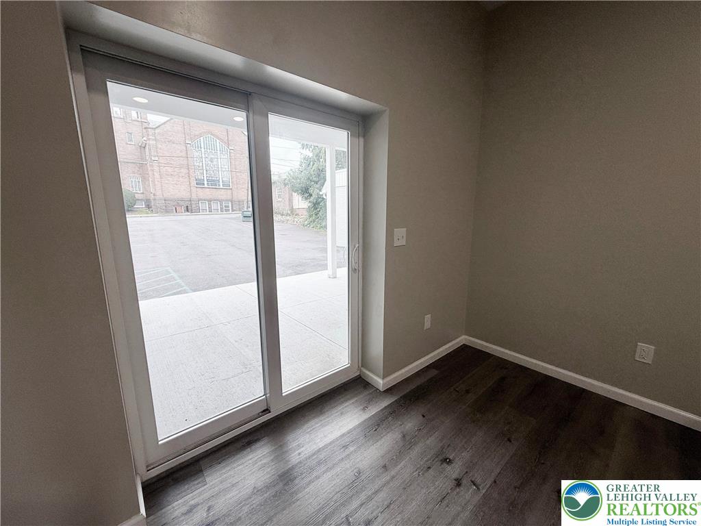 801 West Broad Street, Unit 1 Bethlehem, PA 18018 - Photo 17 of 31 a view of an empty room with wooden floor and a window