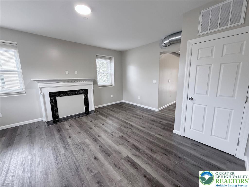 801 West Broad Street, Unit 1 Bethlehem, PA 18018 - Photo 6 of 31 an empty room with wooden floor and a window