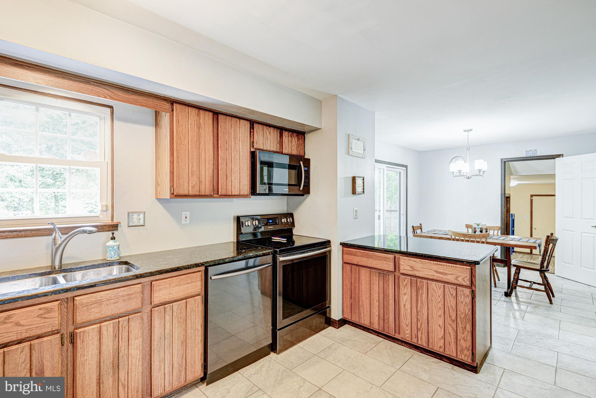 8 Risa Court Newark, DE 19702 - Photo 35 of 58 a kitchen with stainless steel appliances a sink stove and cabinets