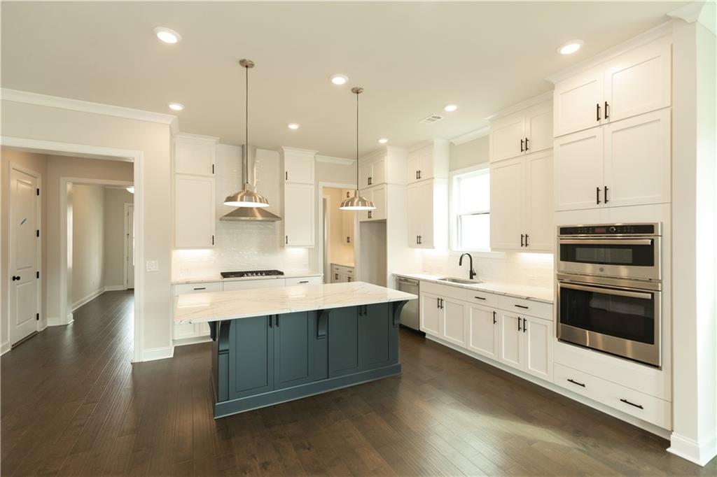 185 Idylwilde Way Canton, GA 30115 - Photo 1 of 1 a kitchen with stainless steel appliances kitchen island granite countertop a stove a sink and a refrigerator