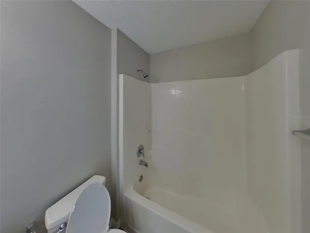 a bathroom with a bathtub and toilet