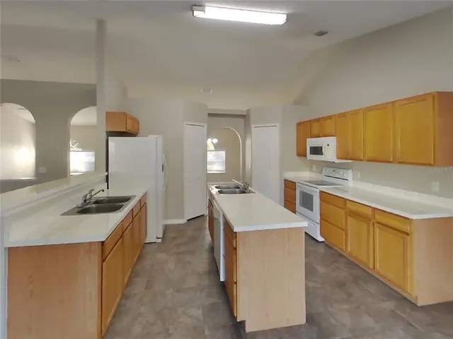 a kitchen with stainless steel appliances granite countertop a stove oven and a refrigerator