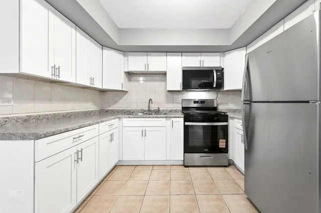 a kitchen with a sink a stove and refrigerator