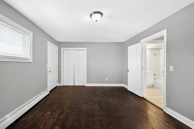 a view of a room with wooden floor and windows