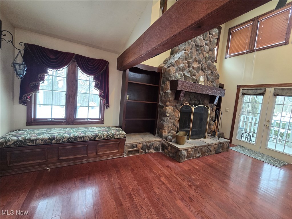 4300 Poe Road Medina, OH 44256 - Photo 9 of 45 Great room featuring a fireplace, wood finished floors, vaulted ceiling, and french doors