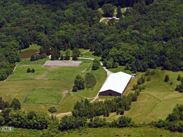 an aerial view of a house with yard swimming pool and outdoor seating