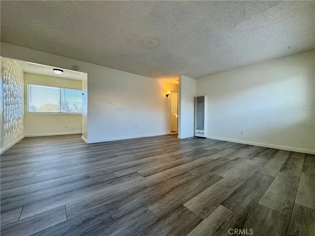 a view of an empty room and wooden floor