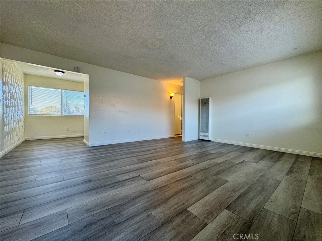 a view of an empty room and wooden floor