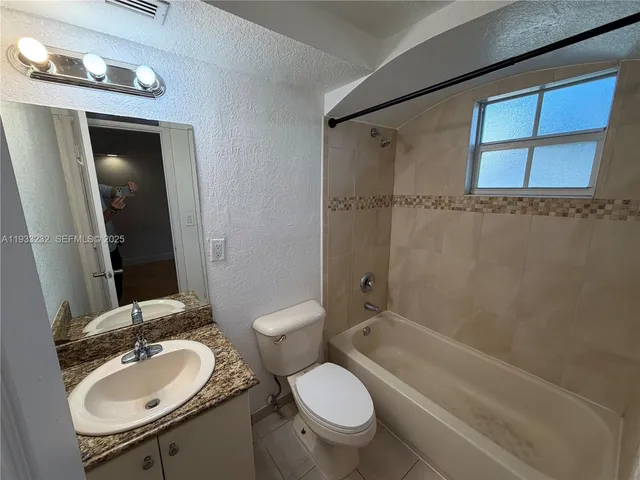 a bathroom with a sink toilet mirror and shower