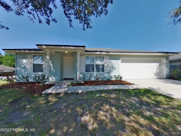 a front view of house with yard and outdoor seating