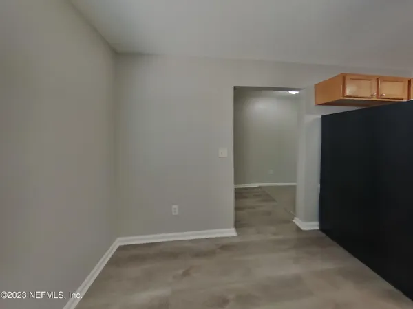 a kitchen with granite countertop a refrigerator a stove top oven and a sink