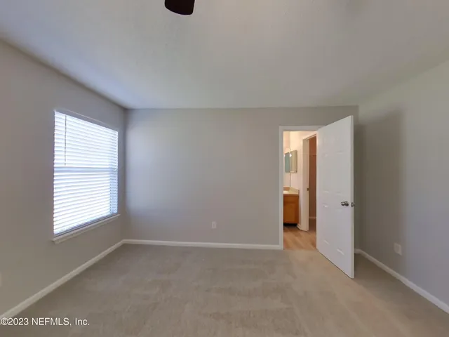 a spacious bathroom with a sink and a mirror