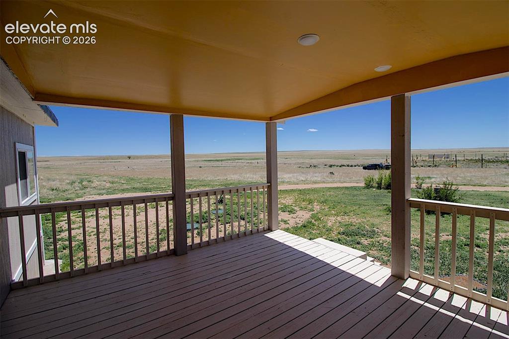 3425-3435 Wiesner Road Calhan, CO 80808 - Photo 17 of 25 Wooden terrace featuring a rural view