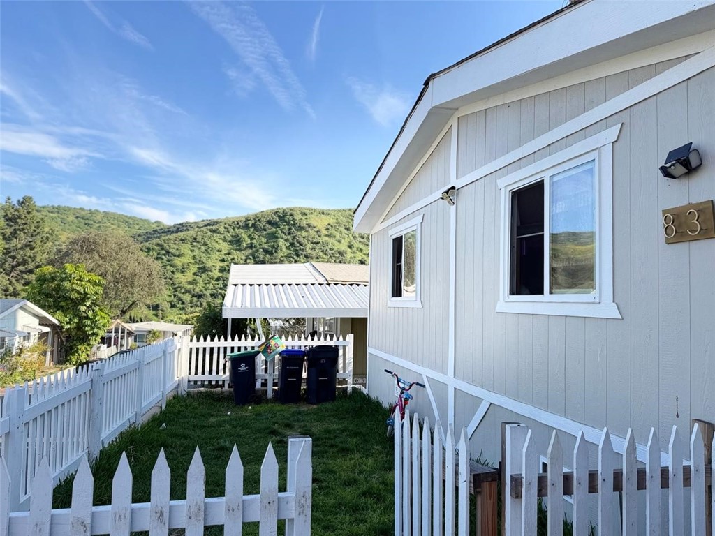 a view of a house with wooden deck and furniture