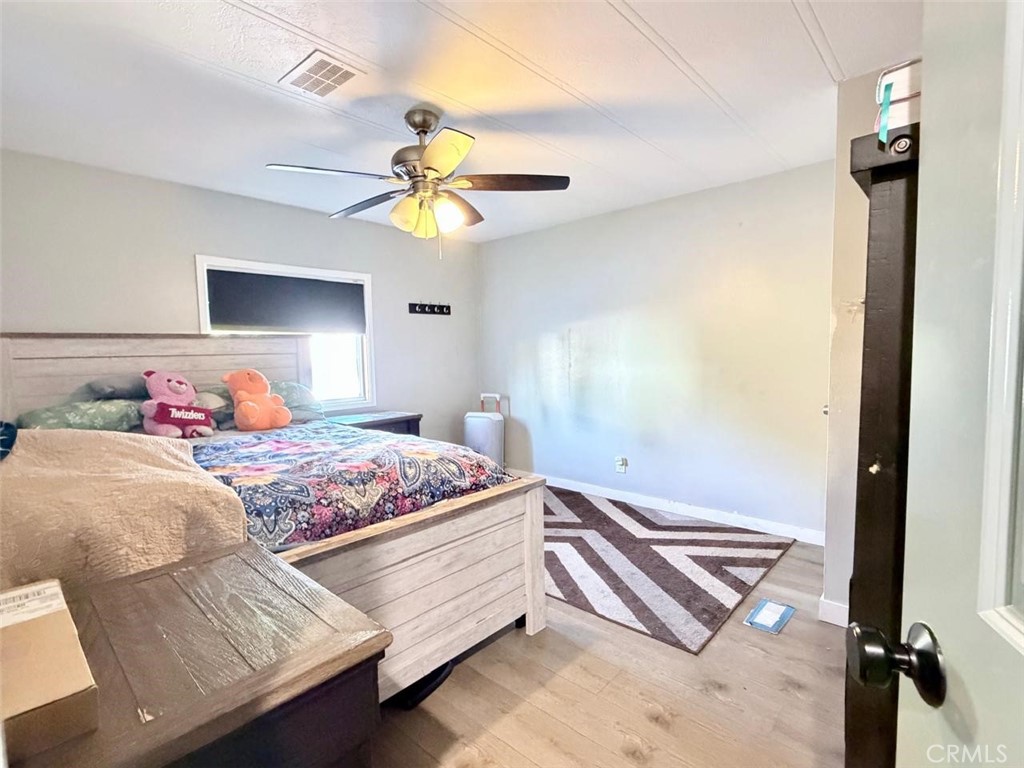 5700 Carbon Canyon Road, Unit 83 Brea, CA 92823 - Photo 9 of 24 a bedroom with a bed and a chandelier