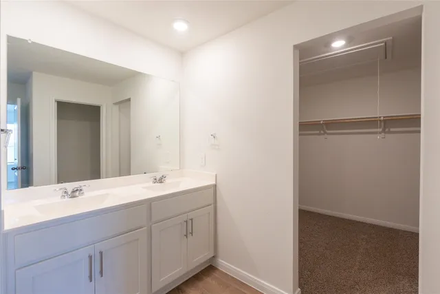 a bathroom with a double vanity sink and mirror