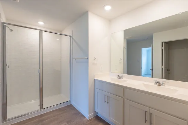 a bathroom with double vanity sinks and a mirror