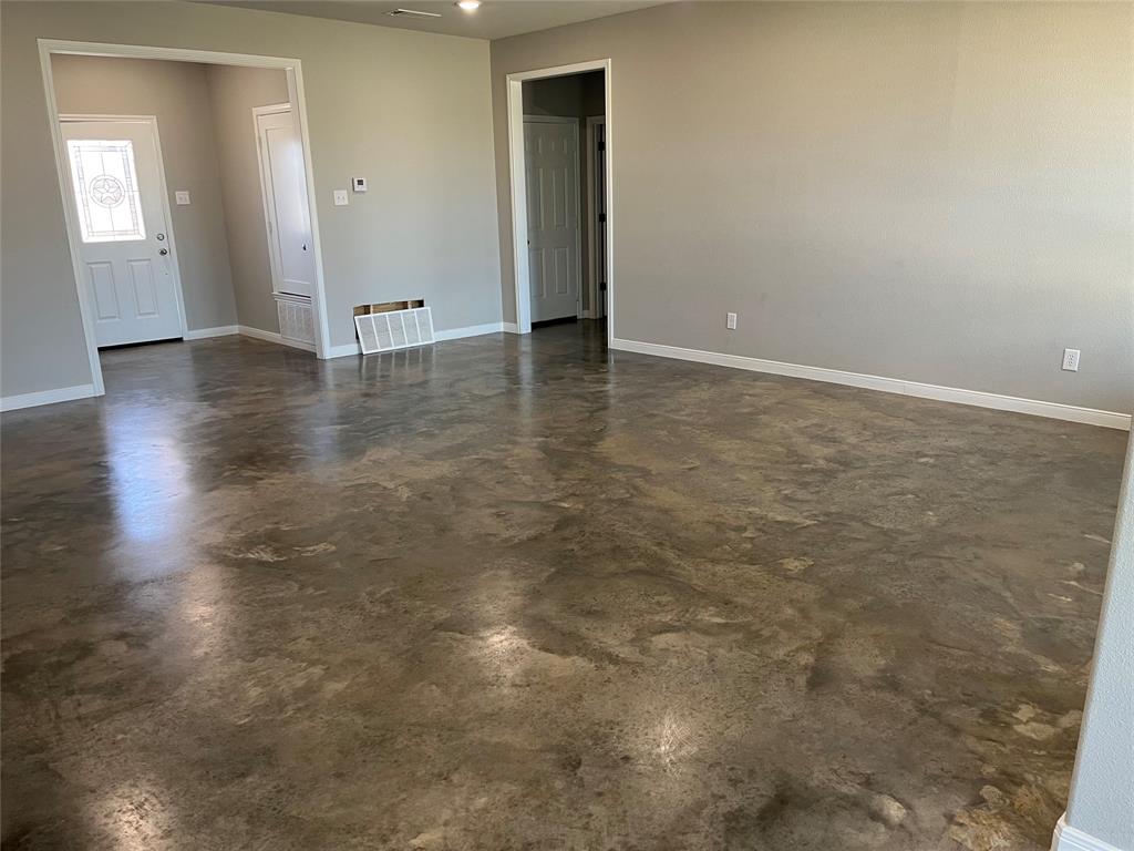 1043 Cr 327a Glen Glen Rose, TX 76043 - Photo 2 of 10 an empty room with wooden floor and windows
