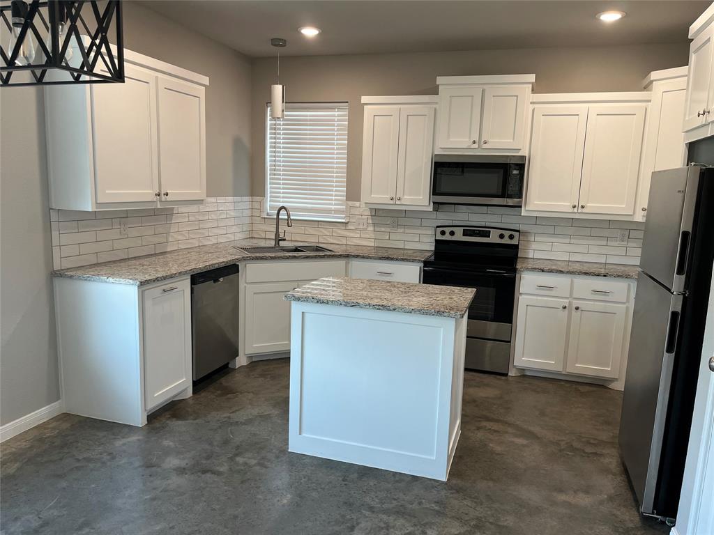 1043 Cr 327a Glen Glen Rose, TX 76043 - Photo 3 of 10 a kitchen with stainless steel appliances granite countertop a stove a sink and a refrigerator