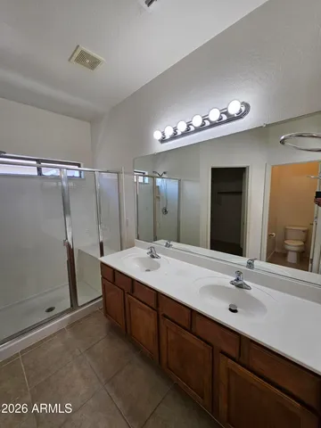 a bathroom with a double vanity sink and a mirror