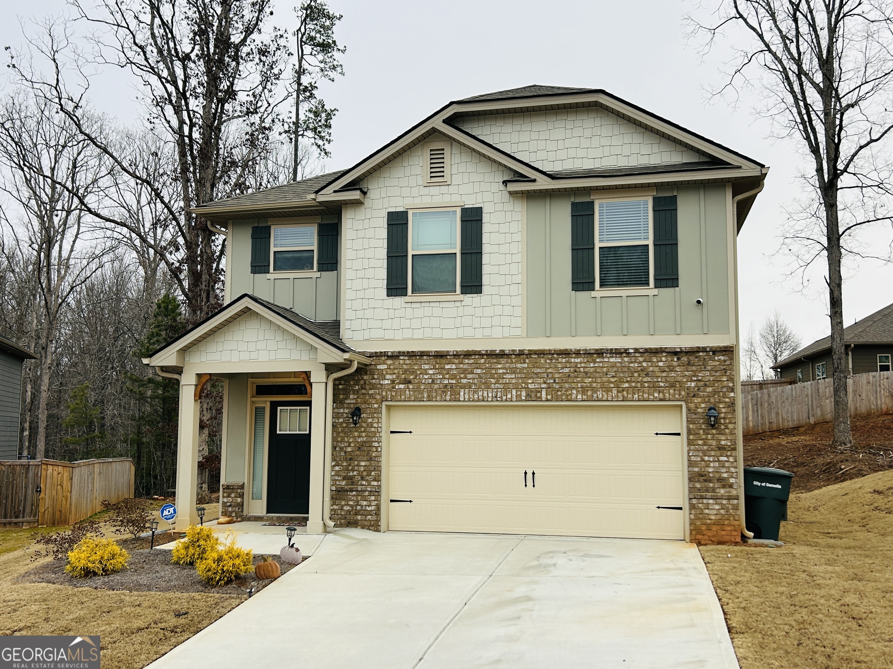 a front view of a house with yard porch and garage
