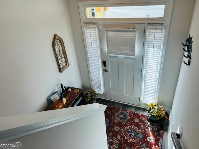 a room with a door and a potted plant