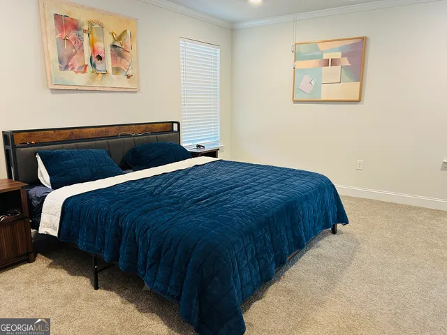 a bedroom with a bed and wall painting