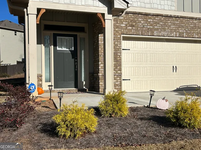 a backyard of a house with outdoor seating
