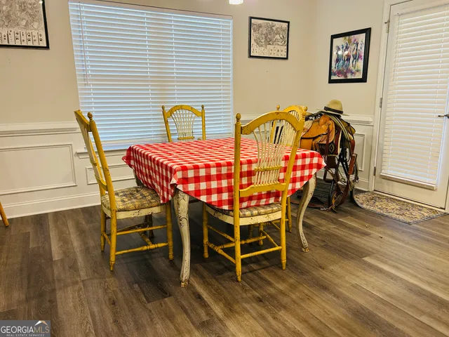 a view of a dining room with furniture and wooden floor