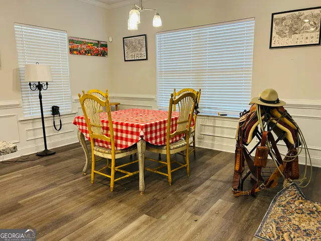 a view of a dining room with furniture and wooden floor