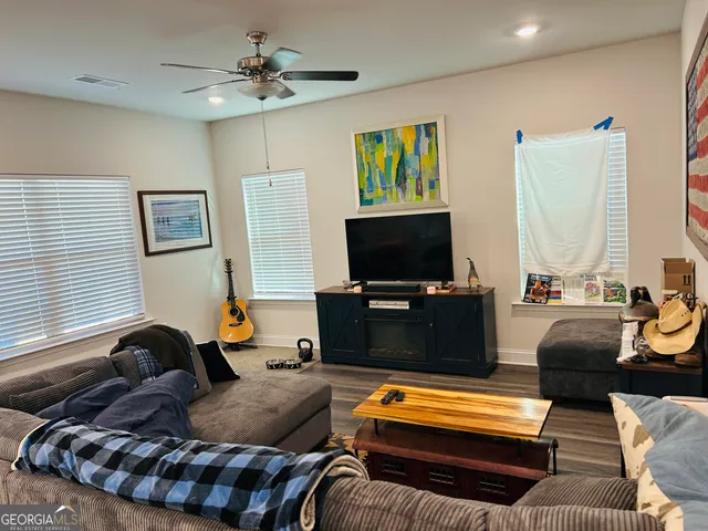 a living room with furniture and a flat screen tv