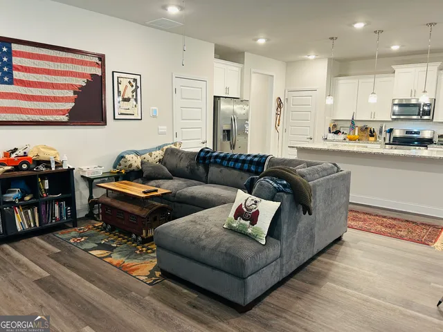 a living room with furniture fireplace and a wooden floor