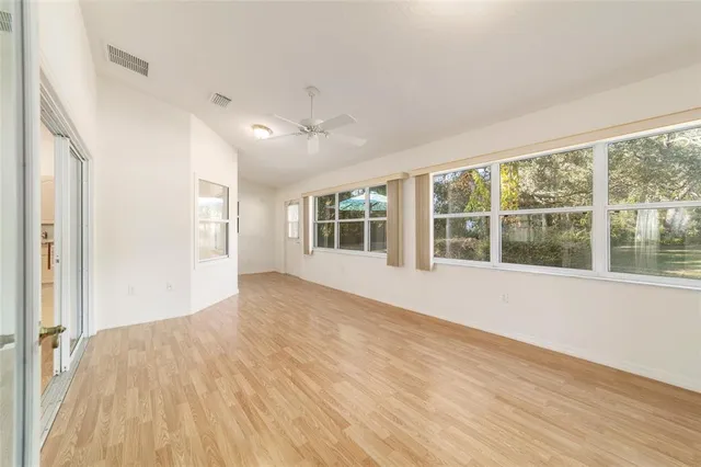 a view of an empty room with closet and a window