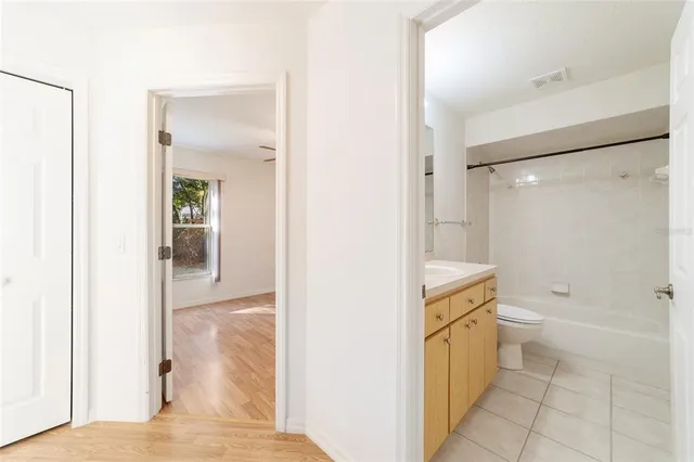 an empty room with closet and windows