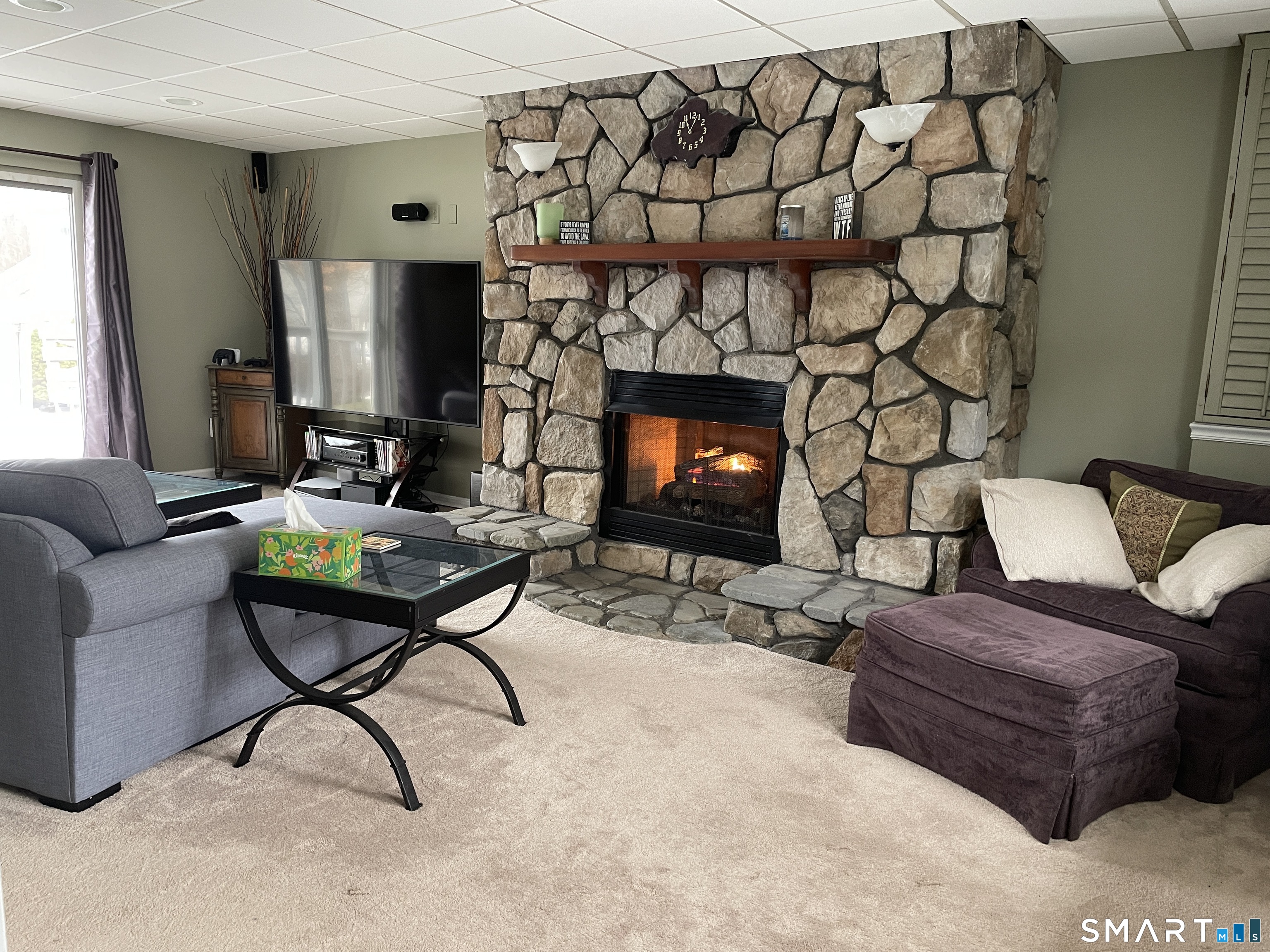 2304 Durham Road Madison, CT 06443 - Photo 14 of 23 Ground level family room with gas FPL and doors to rear enjoys full bath and laundry room (previously used as suite)