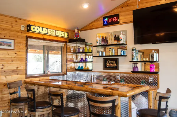 a living room with furniture a fireplace and large windows