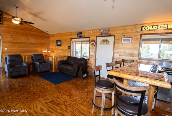 a living room with a bed and a dresser