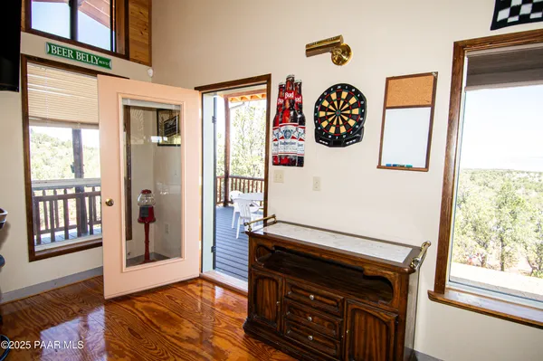 a view of a livingroom with furniture wooden floor and window