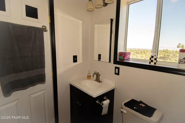 a bedroom with a bed next to a window