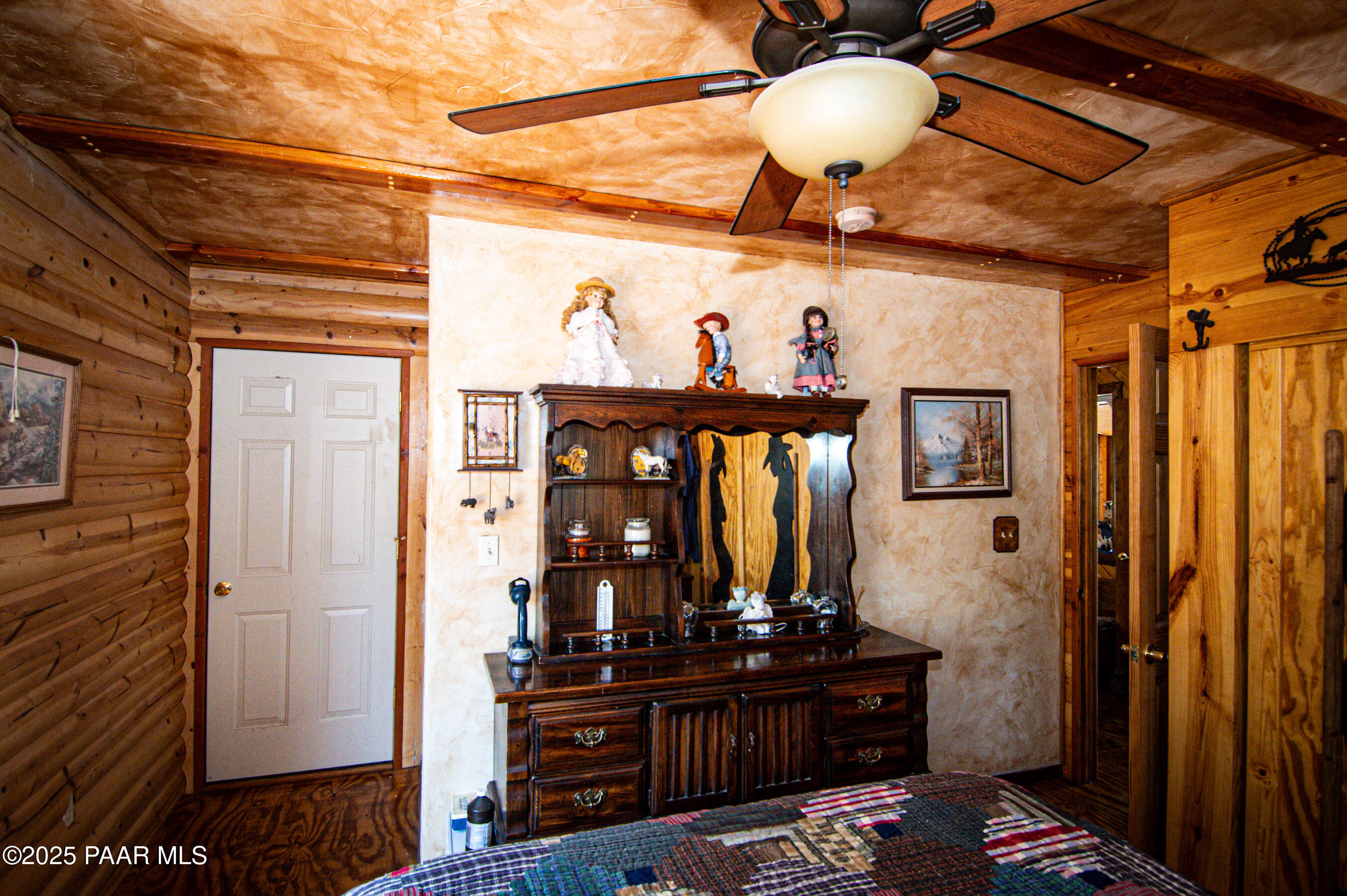 33744 Gallina Road Seligman, AZ 86337 - Photo 27 of 38 a bedroom with a bed and wooden floor
