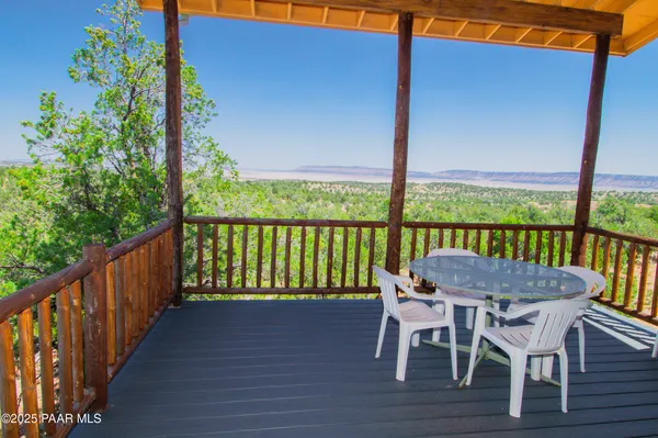 a view of a balcony with a table & chairs
