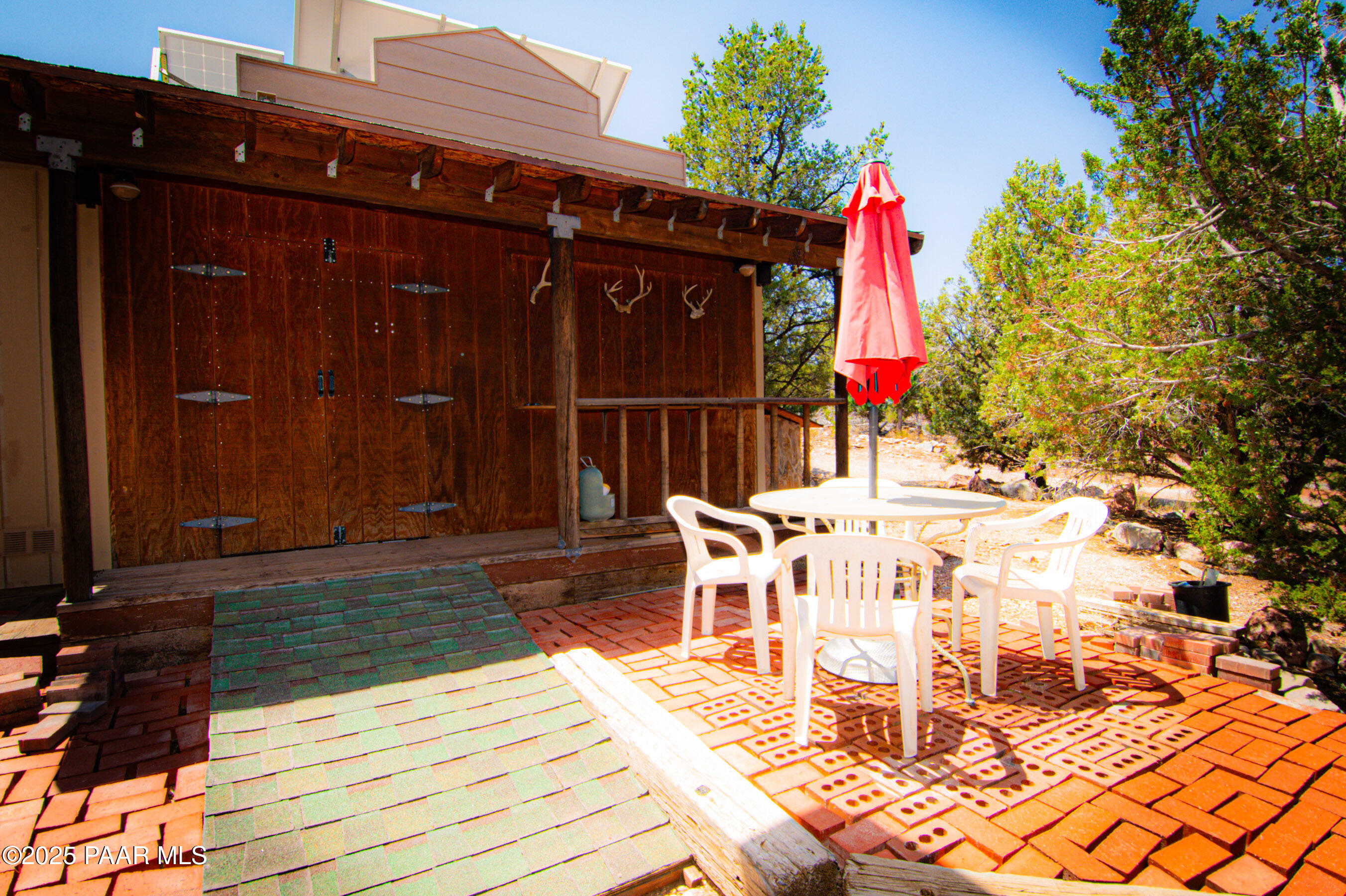 33744 Gallina Road Seligman, AZ 86337 - Photo 34 of 38 a view of a patio with table and chairs with wooden floor and fence