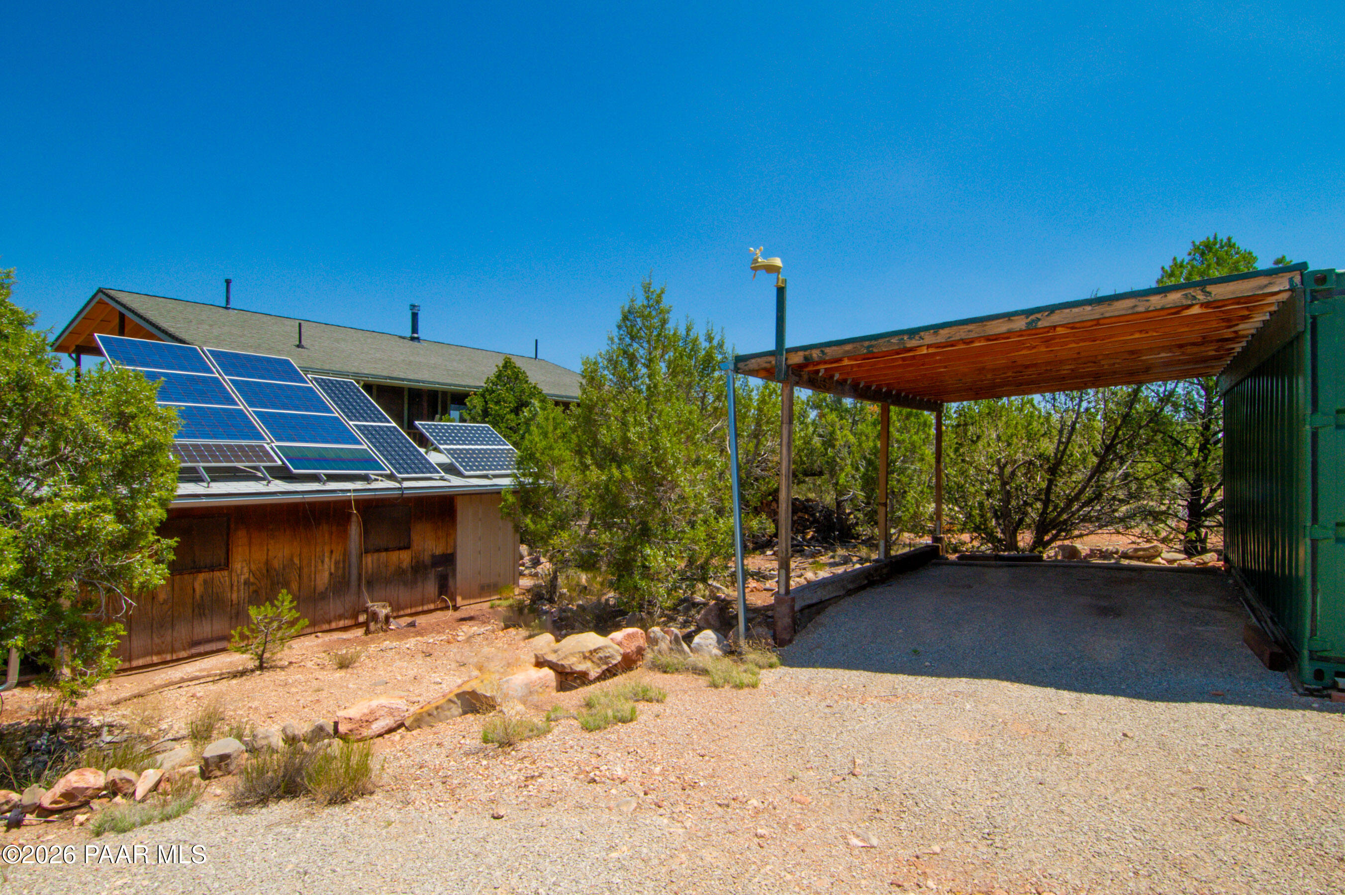 33744 Gallina Road Seligman, AZ 86337 - Photo 36 of 38 a backyard of a house with table and chairs under an umbrella