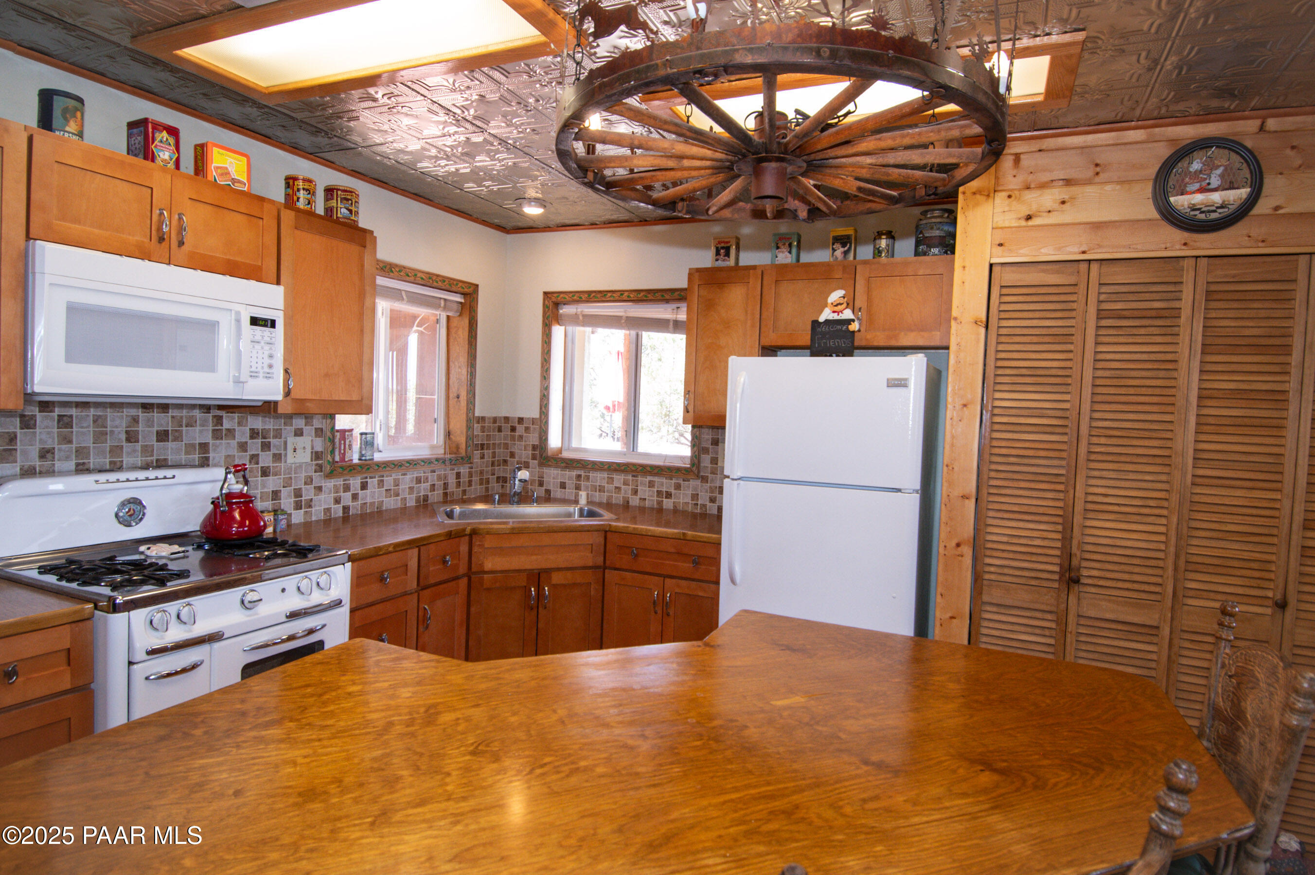 33744 Gallina Road Seligman, AZ 86337 - Photo 5 of 38 a kitchen with stainless steel appliances granite countertop a sink stove and refrigerator