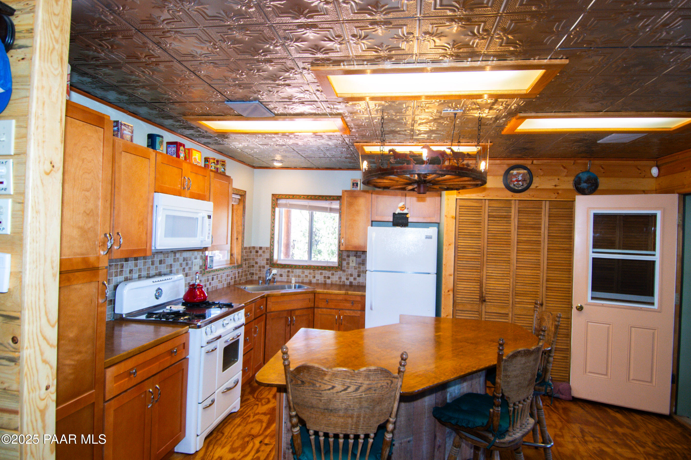 33744 Gallina Road Seligman, AZ 86337 - Photo 6 of 38 a view of a dining room with furniture a chandelier and wooden floor