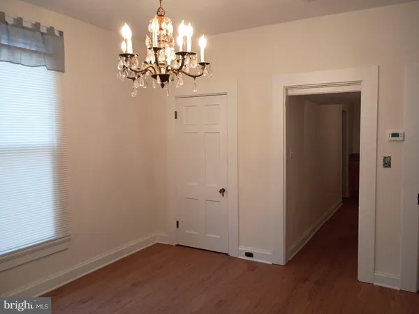 a view of a hallway with chandelier